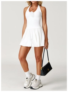Detail of white halter neck mini dress with 3D mesh floral brooch and pleated hem