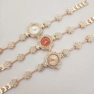 Detailed view of floral rhinestone watches in gold, white, and red dial variants
