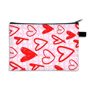 Pink Valentine's cosmetic bag with red hearts and XO prints, top zipper closure