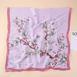 Detailed close-up of lavender silk scarf featuring white magnolia floral prints