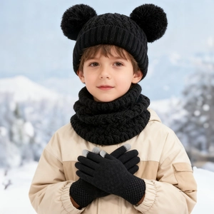 Close-up of kids winter knit set featuring black double pom-pom hat and thick scarf