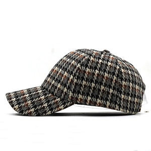 Close-up of thick houndstooth fabric texture on vintage brown and black baseball cap