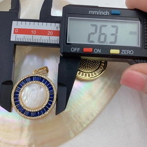 Detailed view of Our Lady of Guadalupe pendant showing a diameter of 26.3 mm