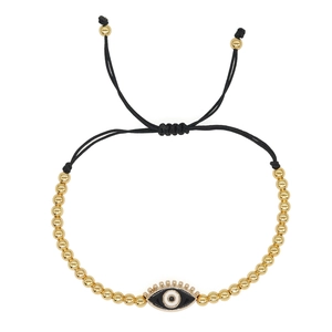 Detail of evil eye charm and 4mm copper beads on black woven cord bracelet