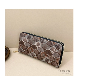 Detailed embroidery of geometric shell patterns on a long zipper wallet for women