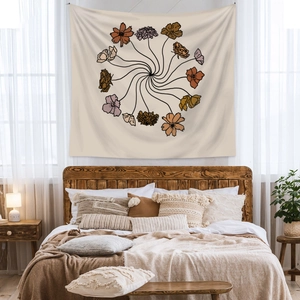 Detail of bohemian floral tapestry with a spiral flower pattern on a beige fabric background