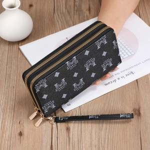 Detail of black double-zipper long wallet with wrist strap and gold-tone hardware detail