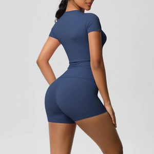 Back view of slim fit navy blue yoga set featuring short sleeve top and high waist shorts