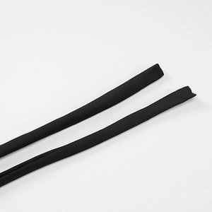Close-up of black spaghetti straps showing fine fabric texture of a backless dress