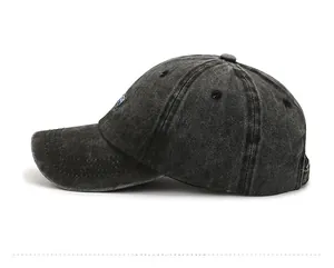Side view of washed charcoal cotton baseball cap with blue logo and vintage texture