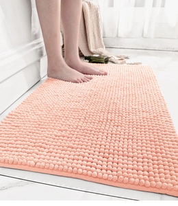 Close-up of pink chenille bath mat with soft absorbent texture and anti-slip backing