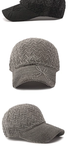 Detailed macro view of black and grey mesh knit baseball caps with leaf embroidery