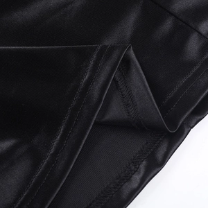 Gros plan sur les coutures de l'ourlet d'une robe de soirée en satin noir raffiné