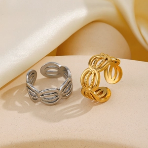 Minimalist geometric hollow woven rings in 18K gold and silver finishes on beige stand