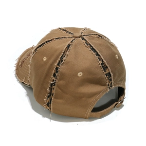 Close-up of distressed cotton baseball cap with leopard print patch and SOS embroidery