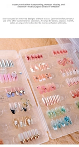 Macro view of clear acrylic nail display box showing various press-on nail art designs