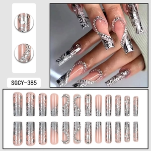 Long nude press-on nails with silver heart patterns and rhinestones, 24-piece full set