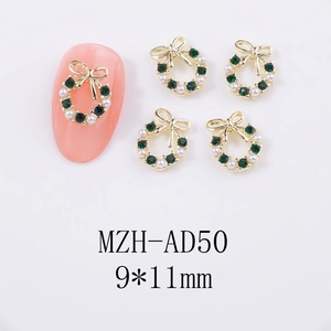 Detailed view of 9x11mm Christmas wreath nail art charms with green rhinestones and pearls
