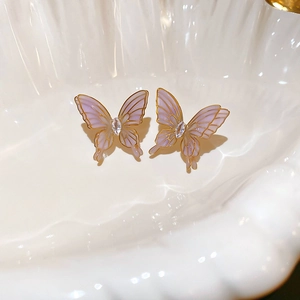 Detail of lavender butterfly earrings with gold plating and white marquise zircon accents