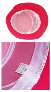 Detail of rose red cotton bucket hat showing white mesh lining and washing label