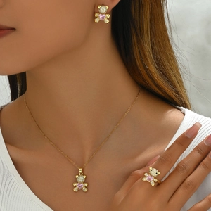 Golden bear jewelry set with pink heart gem and zircon inlay on necklace and ring