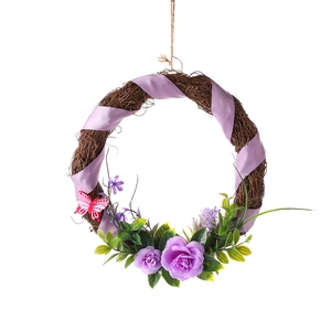 Christmas wreath with purple silk roses and pink butterfly on rustic vine base