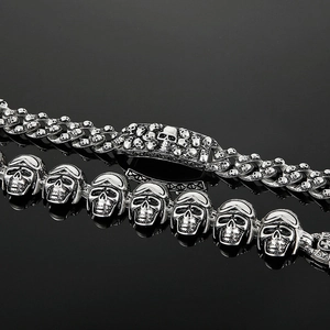 Detailed close-up of retro punk skull stainless steel bracelet with silver-grey finish