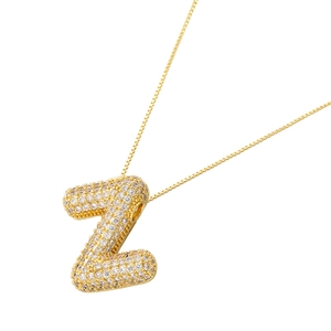 Macro detail of 18K gold plated letter Z pendant with clear cubic zirconia pavé stones