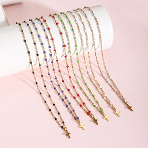 Golden stainless steel cross necklaces with colorful enamel beads in seven vibrant colors