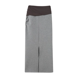 Detail of knit maxi skirt with contrast waist binding and center front slit design