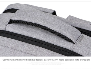 Close-up of padded top handle with breathable mesh lining on a gray business backpack