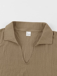Detailed view of brown waffle knit polo shirt showing size L and 100% polyester fabric label