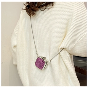 Detailed view of a purple sequin mini crossbody bag with a silver chain and metal clasp