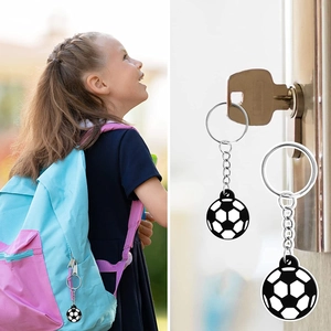 Soccer ball keychain pendant used as a decorative zipper pull on a kid's backpack and keys