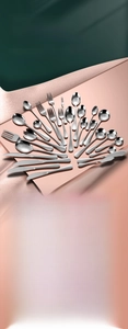 Polished stainless steel cutlery set with knives, forks, and spoons on pink display