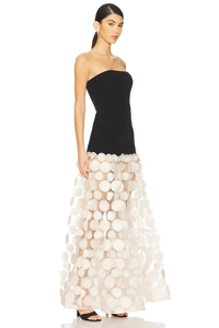 Detail of elegant strapless black bodice joined with white polka dot mesh tulle skirt