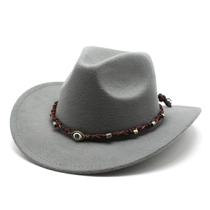 Detail of gray western felt hat with a braided band and evil eye charm decoration