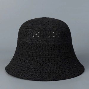 Detailed view of the hollow crochet knit pattern on a black sun bucket hat for women