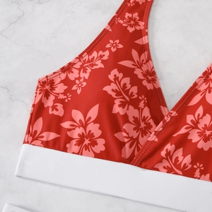 Detail of red floral bikini top with pink hibiscus print and wide elastic white band