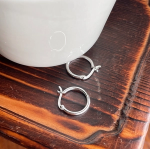 Close-up of S925 sterling silver hoop earrings showing the 925 authenticity hallmark