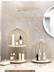 Detail of birdcage-style makeup rack with gold metal frame and marble base texture