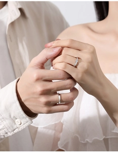 Romantic close-up of S925 silver couple rings featuring minimalist twisted rope design
