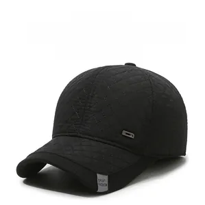 Close-up of quilted black winter baseball cap showing sport fashion label and windproof fabric