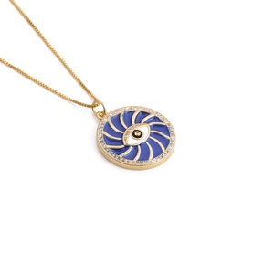 Detailed close-up of gold chain necklace with blue enamel and zircon Evil Eye pendant