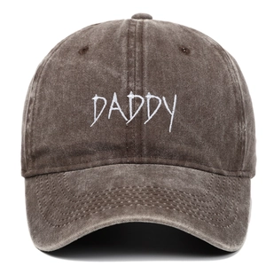 Close-up of DADDY embroidery detail on washed cotton baseball cap with vintage texture