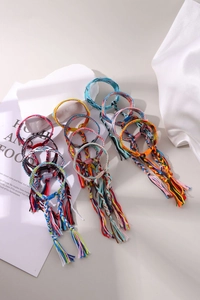 Close-up of assorted handmade bohemian braided friendship bracelets with colorful tassels