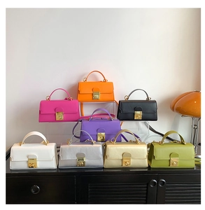 Collection of colorful mini satchels in textured leather with elegant gold clasp
