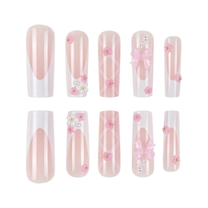 Pink French ombre press-on nails with 3D bows, resin flowers, and pearl accents