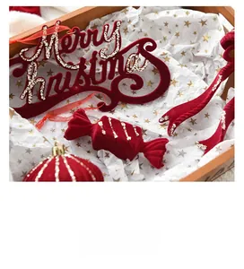 Detail of red velvet Merry Christmas ornaments with gold glitter and candy shapes
