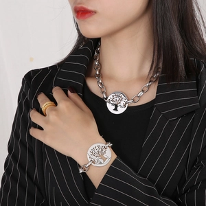 Detail of silver stainless steel thick chain necklace and bracelet with tree of life pendant